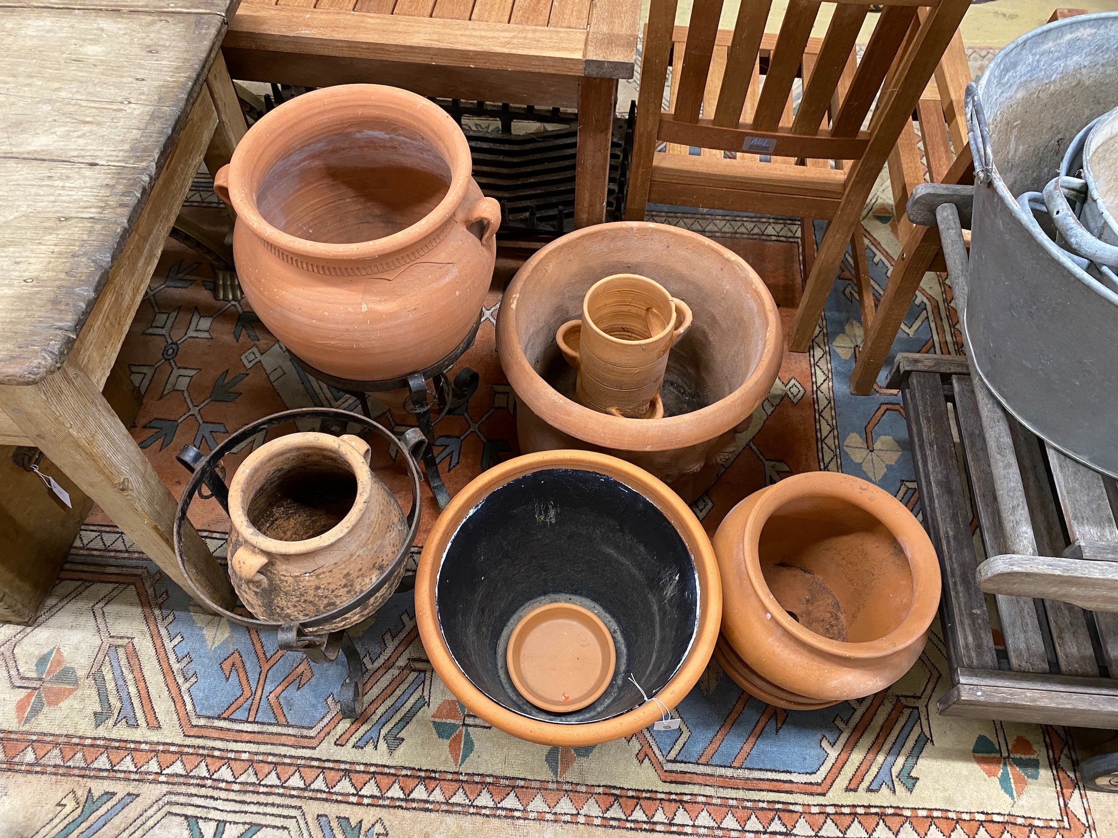 Eight assorted terracotta garden planters and two stands, largest diameter 49cm, height 40cm